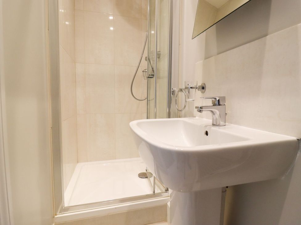 A bathroom with a shower and sink at Peewit Barn in Moreton-in-Marsh