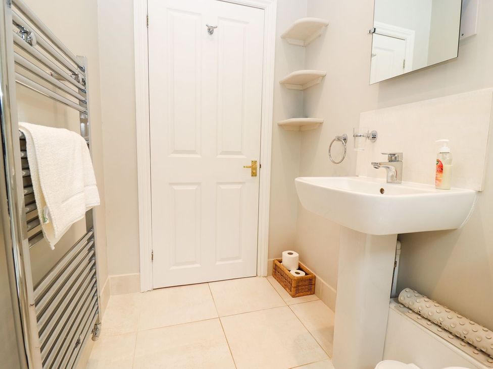 A bathroom with a sink and towel rail at Peewit Barn Moreton-in-Marsh