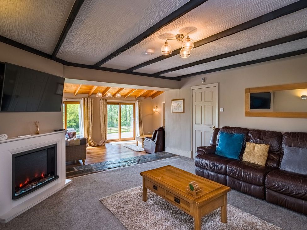 A living room with a sofa and a coffee table at Blaenachddu in Newcastle Emlyn
