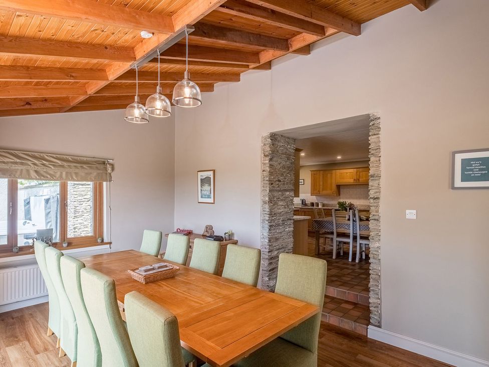 A dining room with a large table and chairs at Blaenachddu Newcastle Emlyn