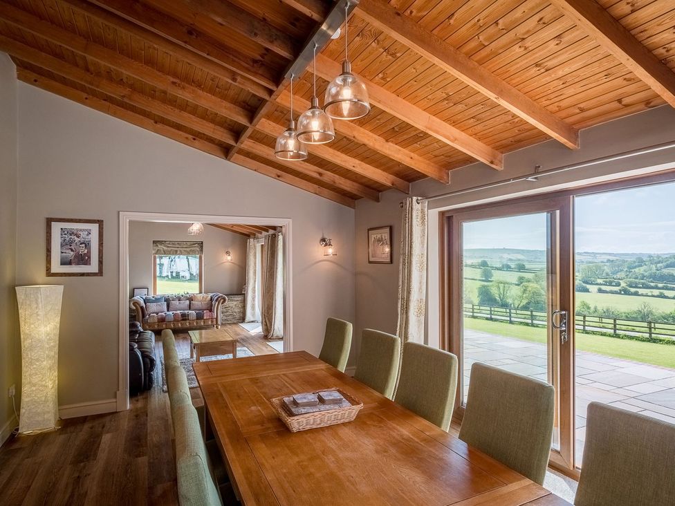 A dining room with a table and chairs at Blaenachddu in Newcastle Emlyn