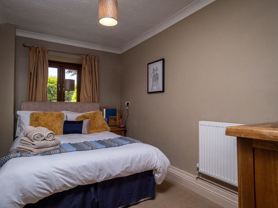 A bedroom with a bed and bedside table at Blaenachddu Newcastle Emlyn