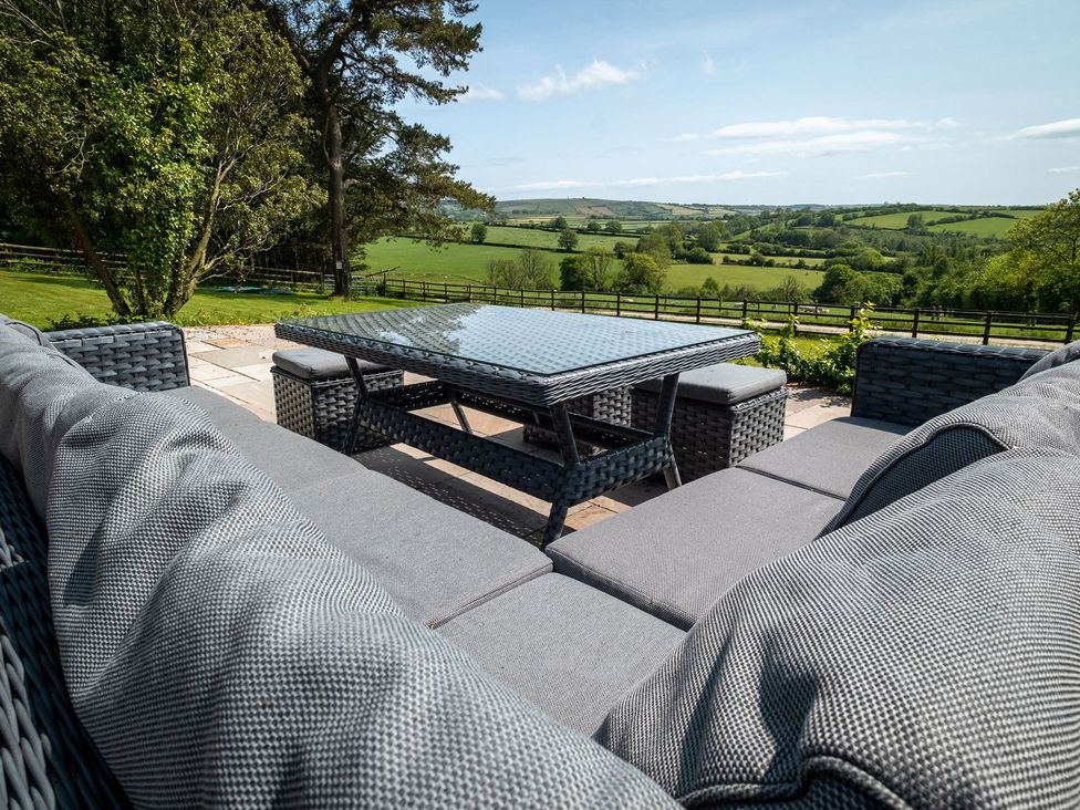 A seating area with table and couch at Blaenachddu Newcastle Emlyn