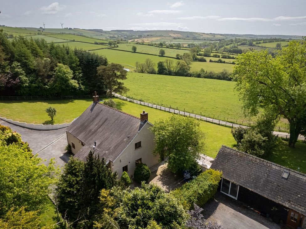 A house surrounded by grass and trees at Blaenachddu Newcastle Emlyn