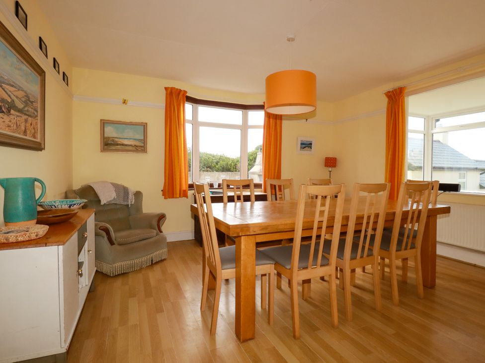 A dining area with a wooden table and chairs at Chy-an-Lowena in Crantock