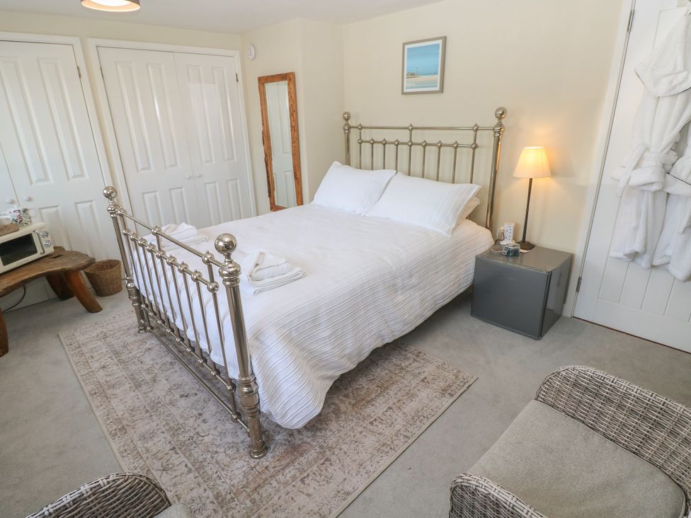A bedroom with a bed and nightstand at Hafan y Tyddyn