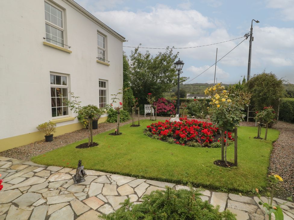 A garden with flowers and a path at Bruckless Rest Fine Country Dining B&B in Bruckless