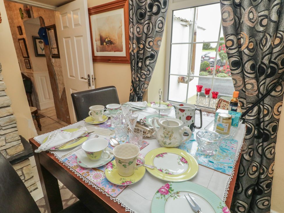 A dining table set with tea cups and a milk jug at Bruckless Rest Fine Country Dining B&B in Bruckless