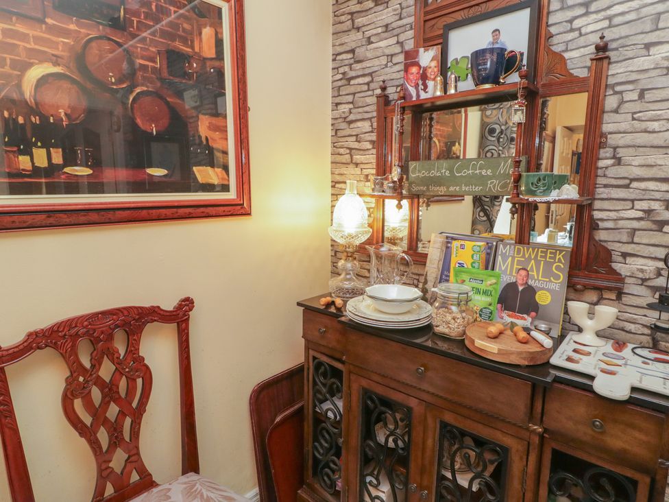 A dining room with a wooden cabinet and decorative items at Bruckless Rest Fine Country Dining B&B in Bruckless