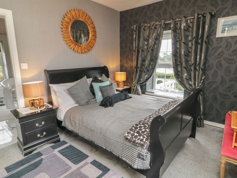 A bedroom with a bed and nightstand at Bruckless Rest Fine Country Dining B&B Bruckless
