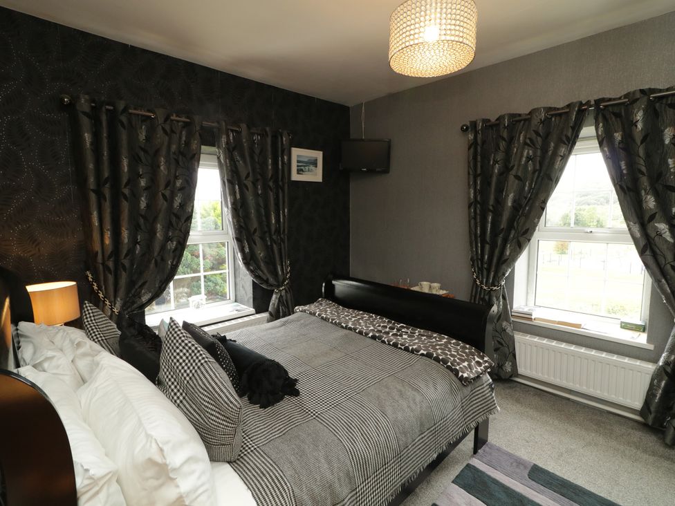 A bedroom with a bed and window at Bruckless Rest Fine Country Dining B&B in Bruckless