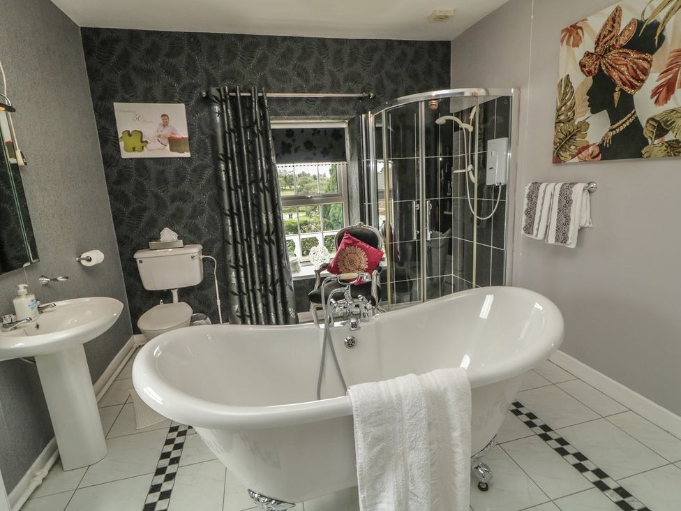 A bathroom with a bathtub and shower enclosure at Bruckless Rest Fine Country Dining B&B, Bruckless