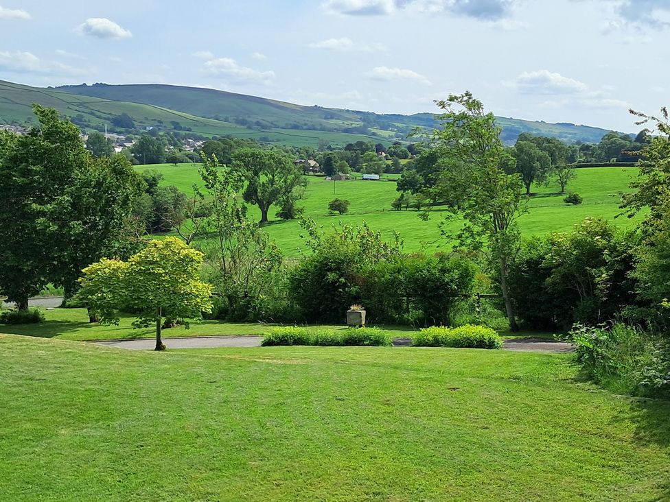 A scenic view of green fields and hills at Castleys Mount in Skipton