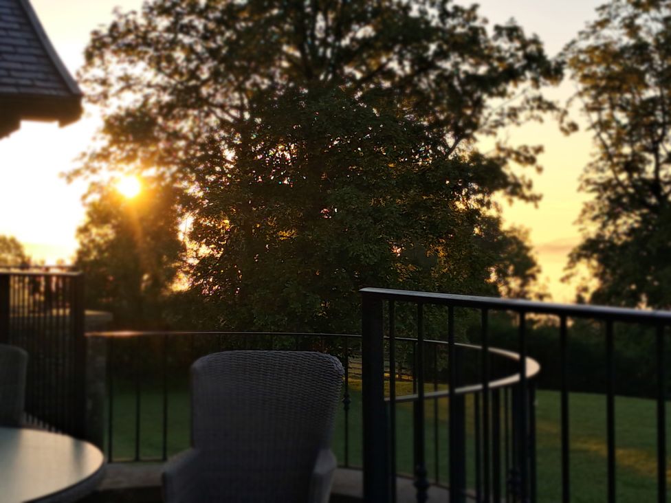 An outdoor area with a tree and furniture at Castleys Mount in Skipton