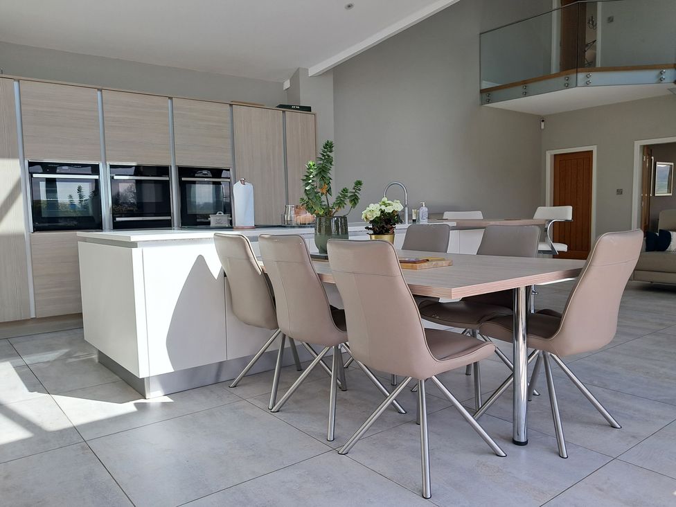 A kitchen with a dining table and chairs at Castleys Mount in Skipton