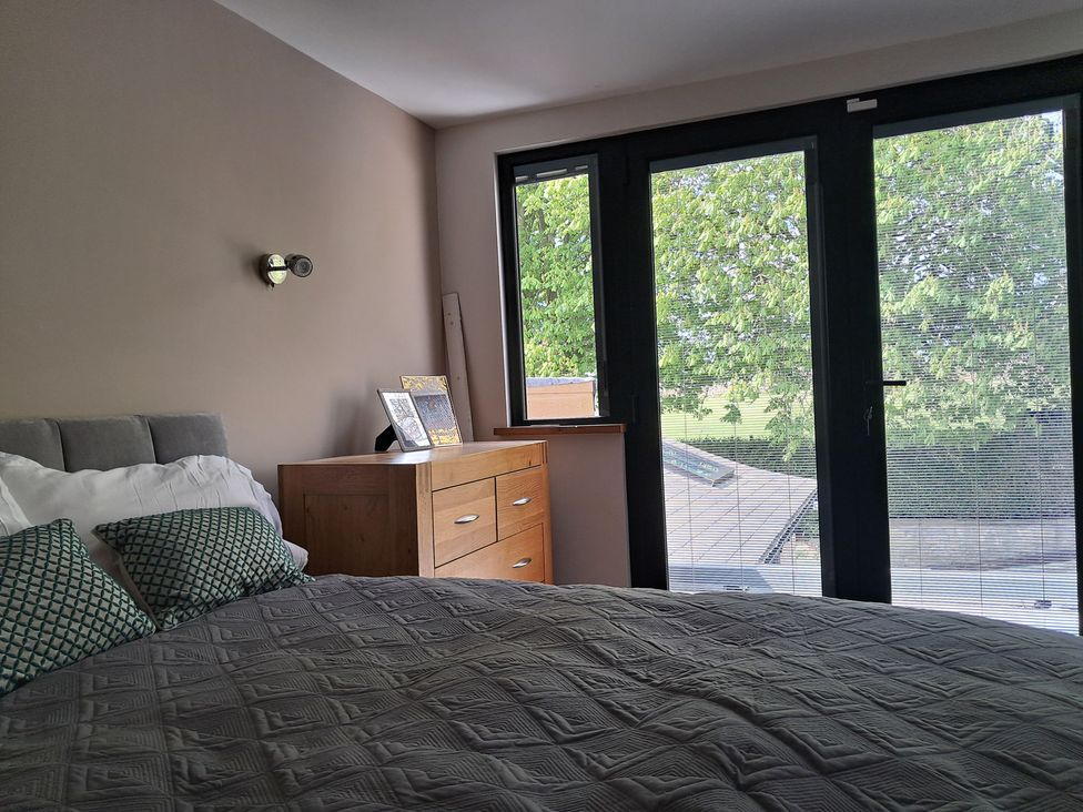 A bedroom with a bed and a dresser at Castleys Mount in Skipton