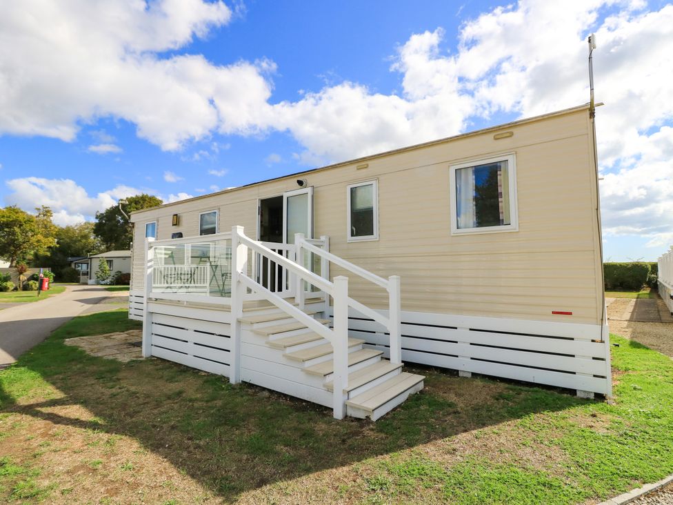 A mobile home with steps and a deck at Beach Retreat in 
