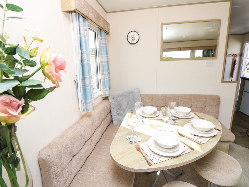 A dining area with a table set for meals at Beach Retreat in 