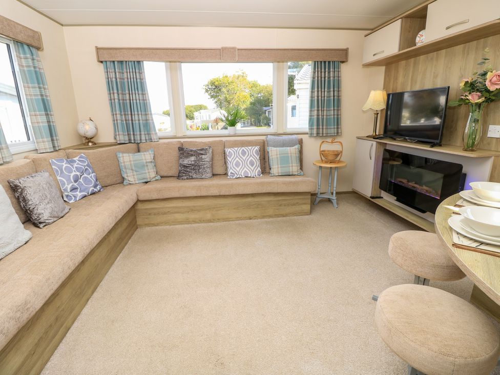 A living room with a sofa and television at Beach Retreat