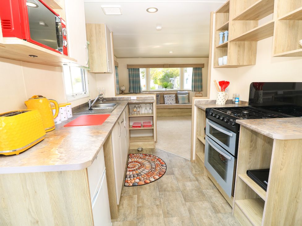 A kitchen with appliances and countertop at Beach Retreat in 