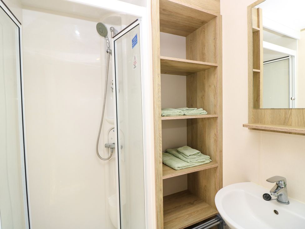 A bathroom with a shower and a sink at Beach Retreat