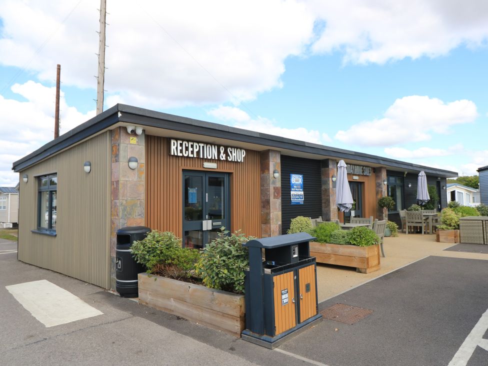 A reception and shop building with seating and plants at Beach Retreat in 