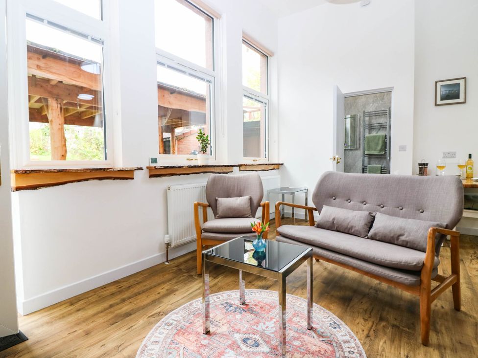 A living room with a sofa and coffee table at The Studio @ 18 in Milnathort