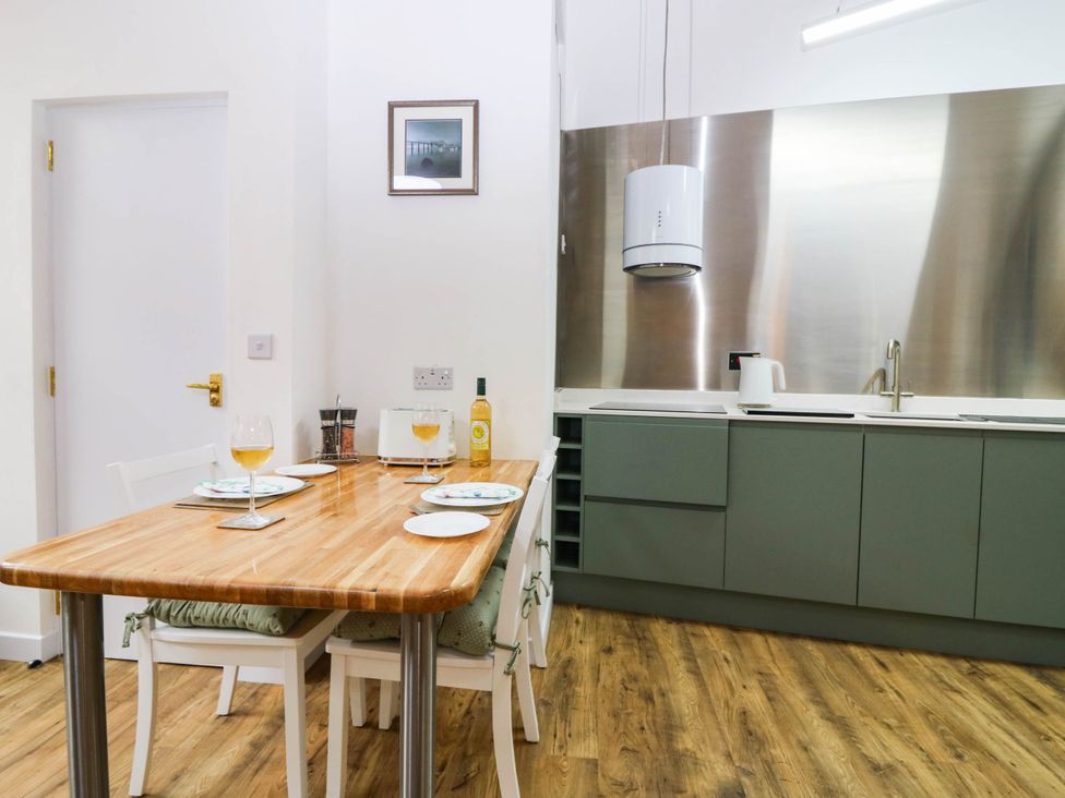 A kitchen with a table and chairs at The Studio @ 18 Milnathort