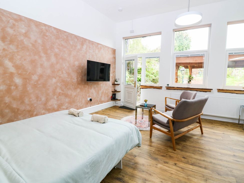 A bedroom with a bed and television at The Studio @ 18 in Milnathort