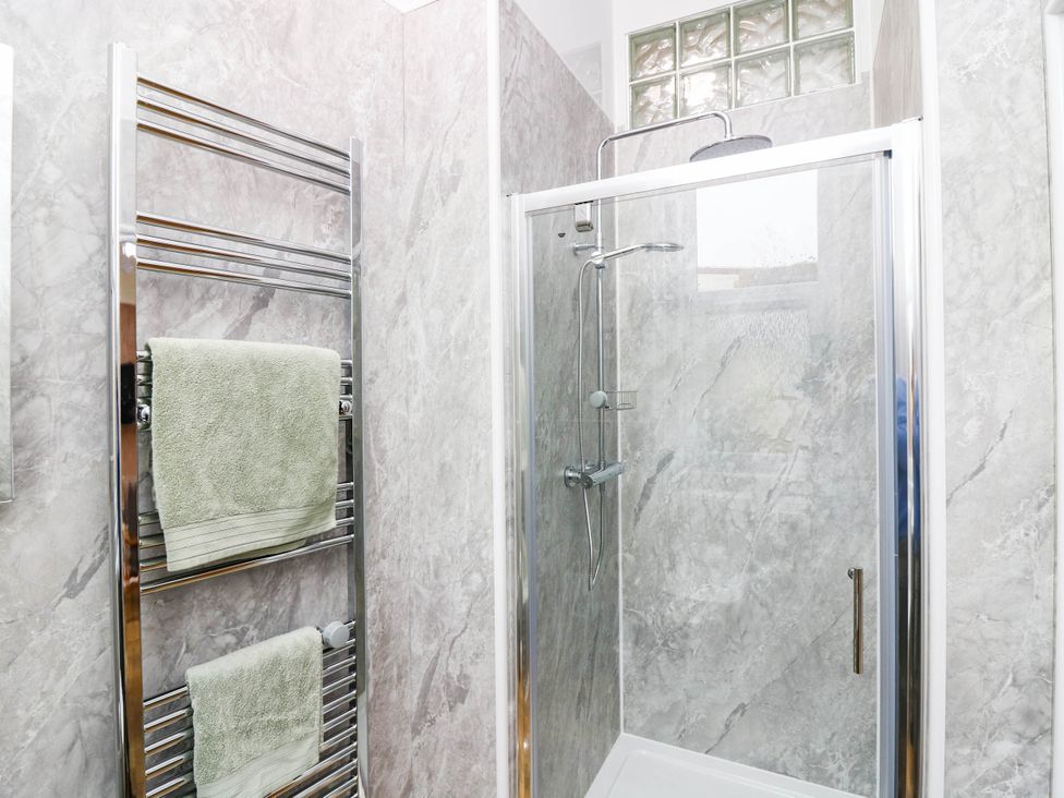 A bathroom featuring a shower and towel rail at The Studio @ 18 Milnathort