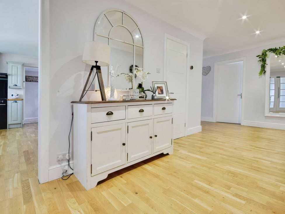 A hallway with a console table and lamp at Gralyn Place