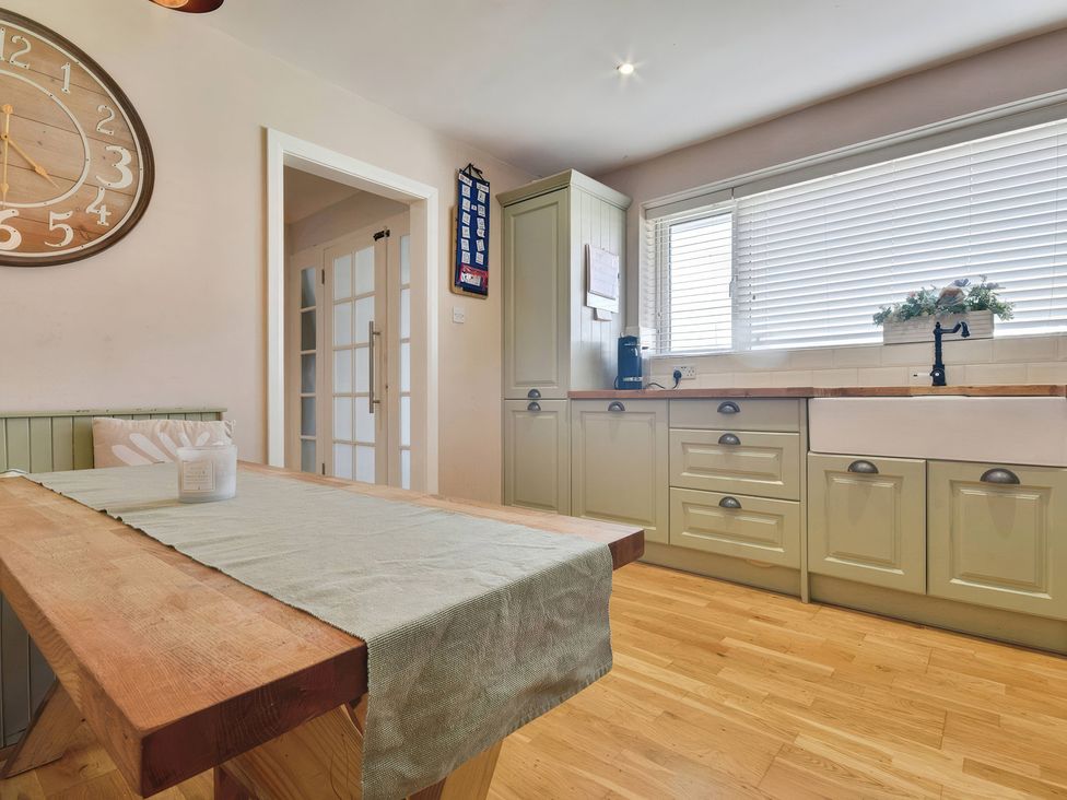A kitchen with a large table and cabinets at Gralyn Place