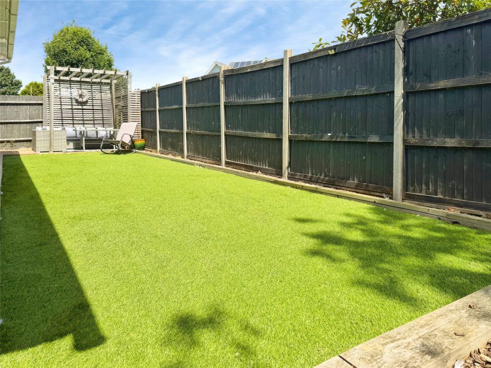 A garden with artificial grass and patio furniture at Gralyn Place