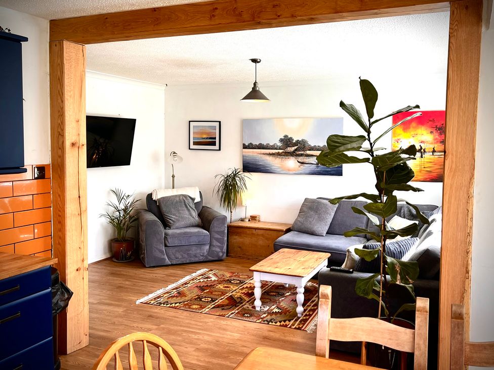 A living room with a sofa and table at Ty Marlyn in St Davids