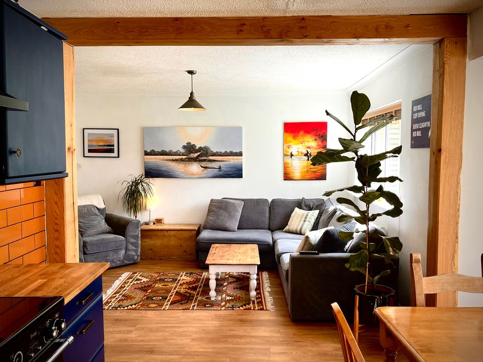 A living room with a sofa and coffee table at Ty Marlyn in St Davids