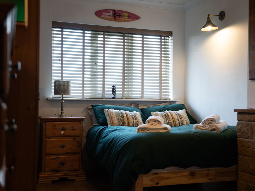 A bedroom with a bed and bedside table at Ty Marlyn in St Davids