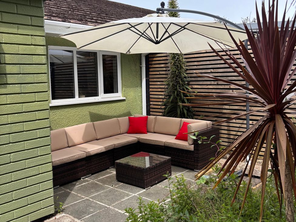 An outdoor seating area with a sofa and table at Ty Marlyn in St Davids