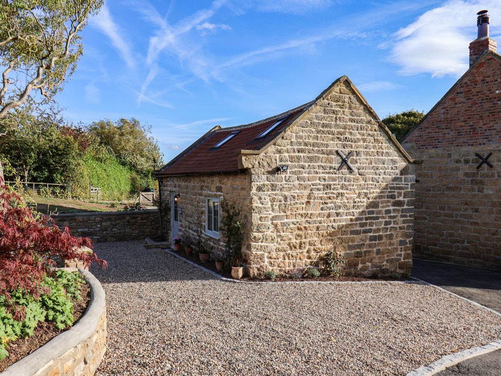 An outdoor view of a stone cottage at Tawny Cottage in Scarborough