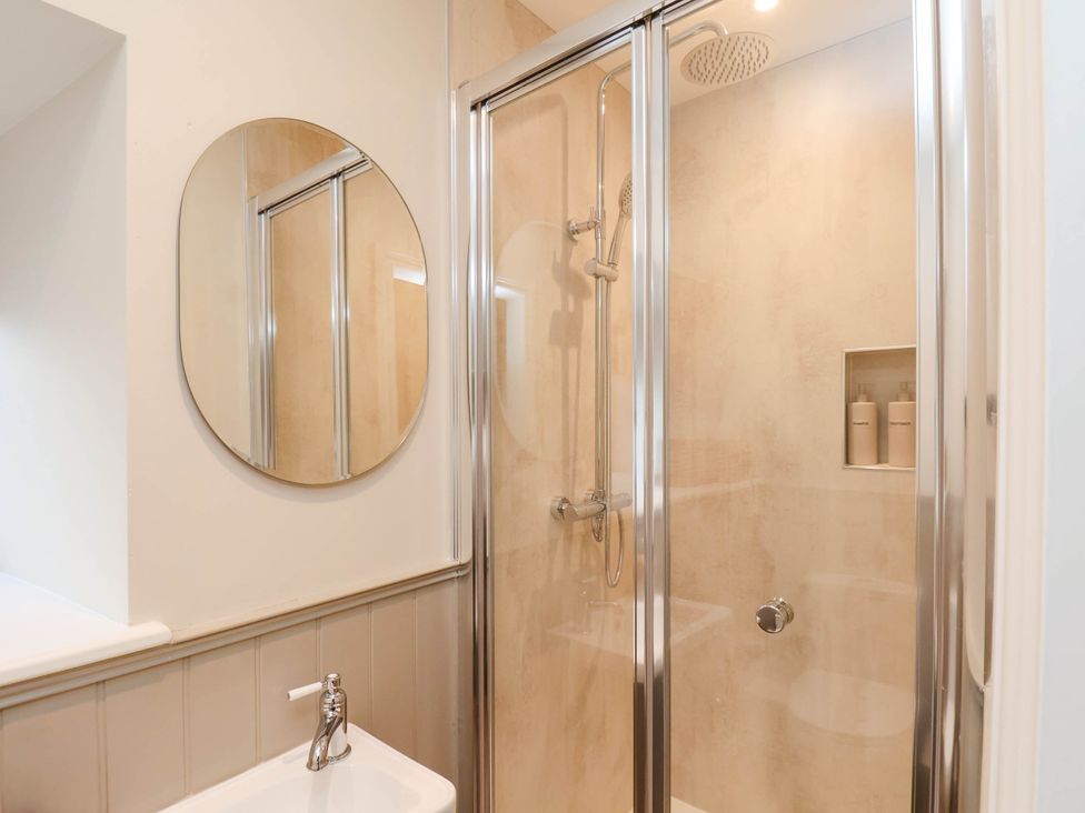 A bathroom with a shower and sink at Tawny Cottage in Scarborough