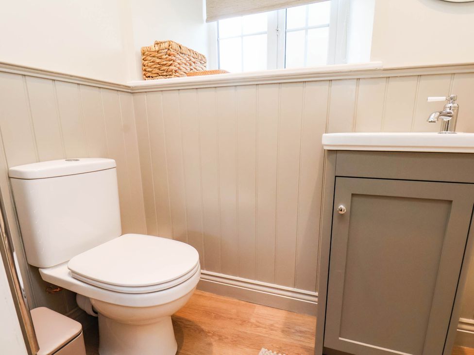 A bathroom with a toilet and a sink at Tawny Cottage in Scarborough