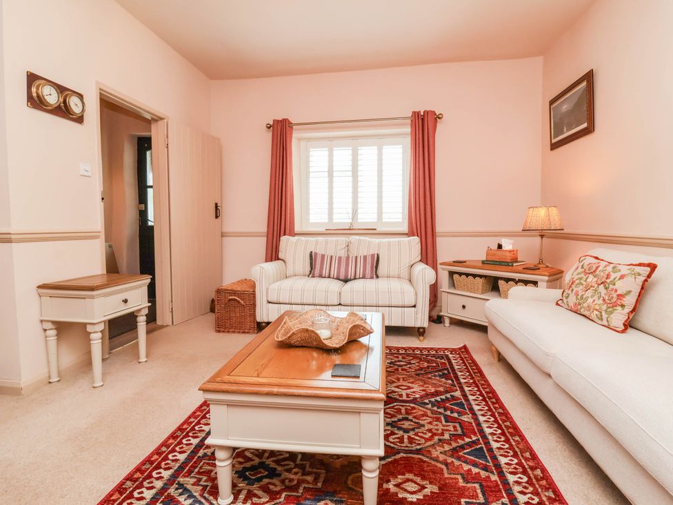 A living room with a sofa and coffee table at Myrtle Cottage in Lynmouth