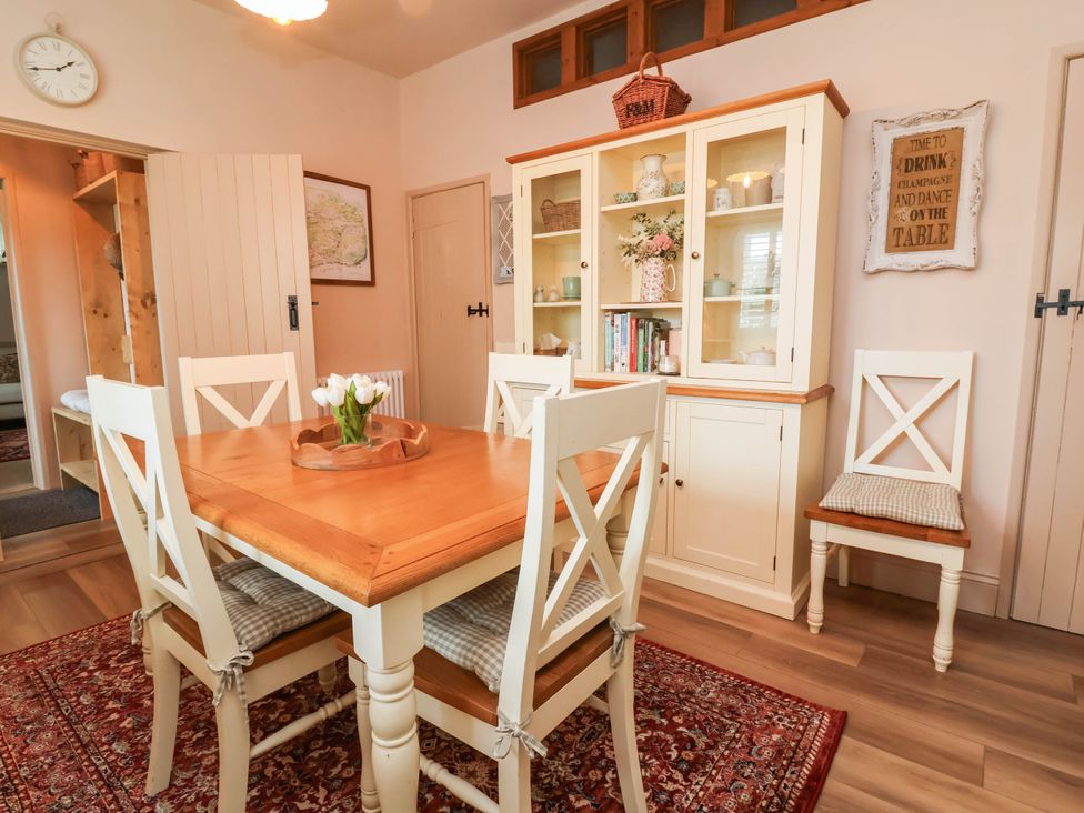 A dining room with a table and chairs at Myrtle Cottage in Lynmouth