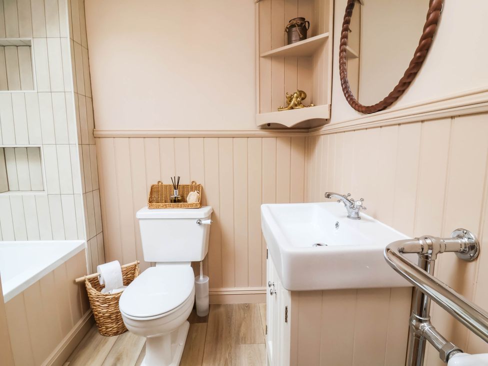 A bathroom with a toilet and sink at Myrtle Cottage in Lynmouth