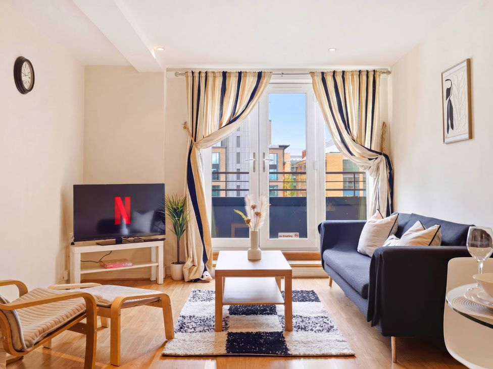 A living room with a television and sofa at Apartment 28 in Birmingham