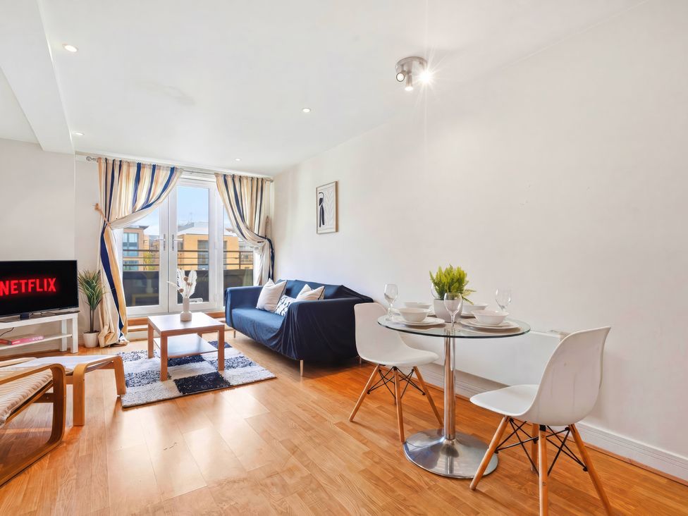A living room with a sofa and dining area at Apartment 28 in Birmingham