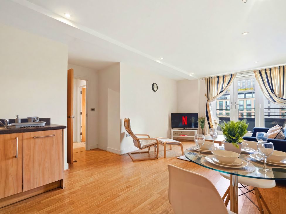 A living room with a dining table and television at Apartment 28 in Birmingham