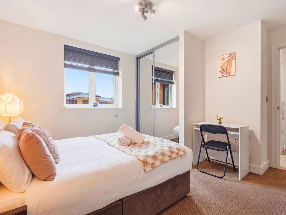 A bedroom with a bed and desk at Apartment 28 in Birmingham