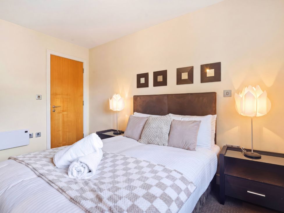 A bedroom with a bed and bedside table at Apartment 28 in Birmingham