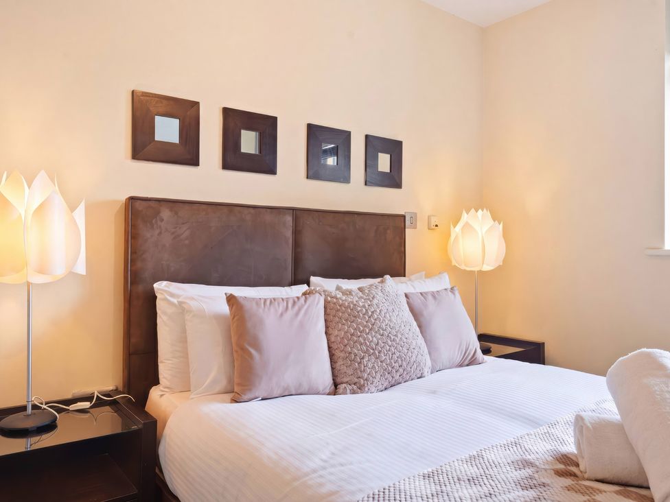 A bedroom with a bed and lamps at Apartment 28 in Birmingham