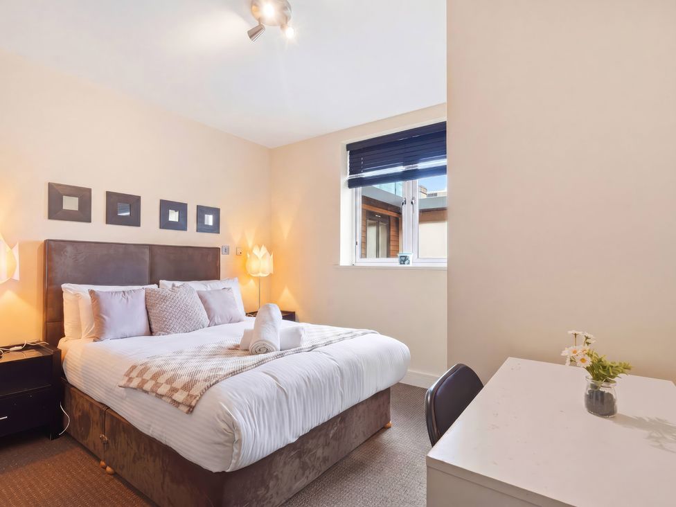 A bedroom with a bed and desk at Apartment 28 in Birmingham
